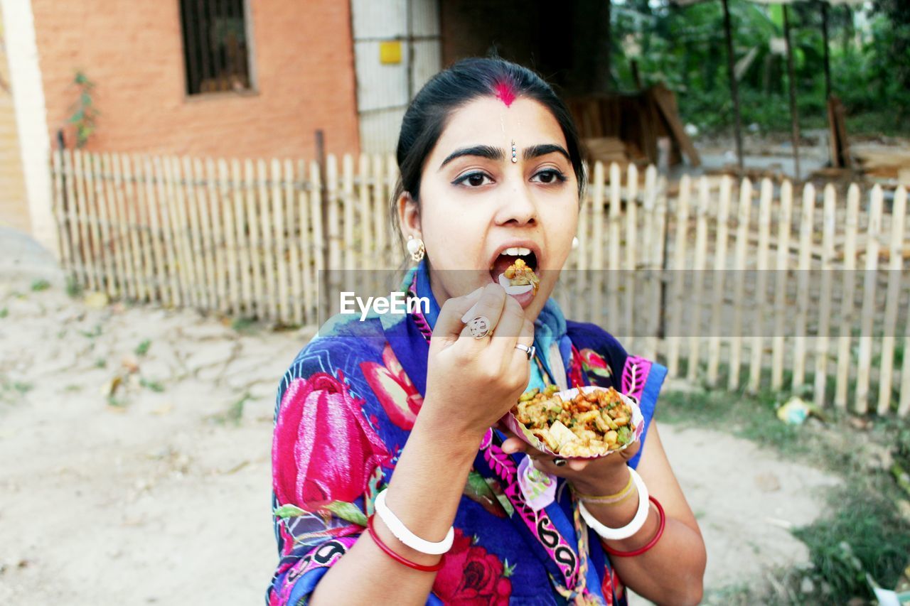Close-up of young woman eating food