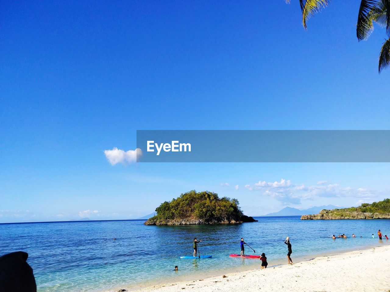 Scenic view of beach against blue sky