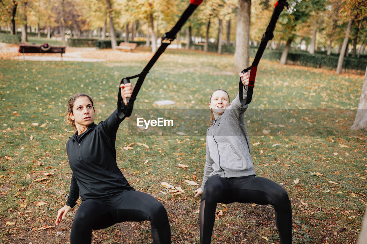 Close-up of smiling woman exercising outdoors