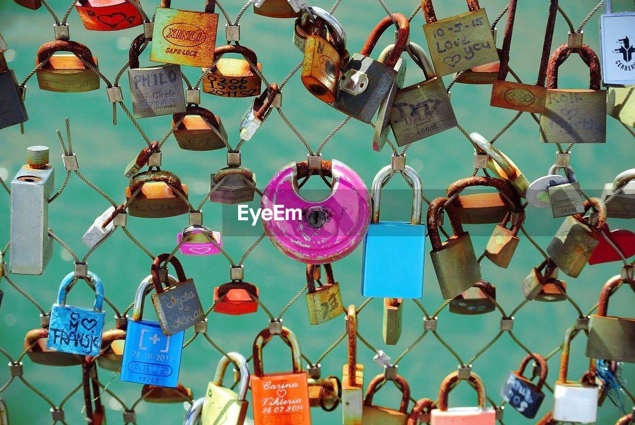 Colorful padlocks attached on fence