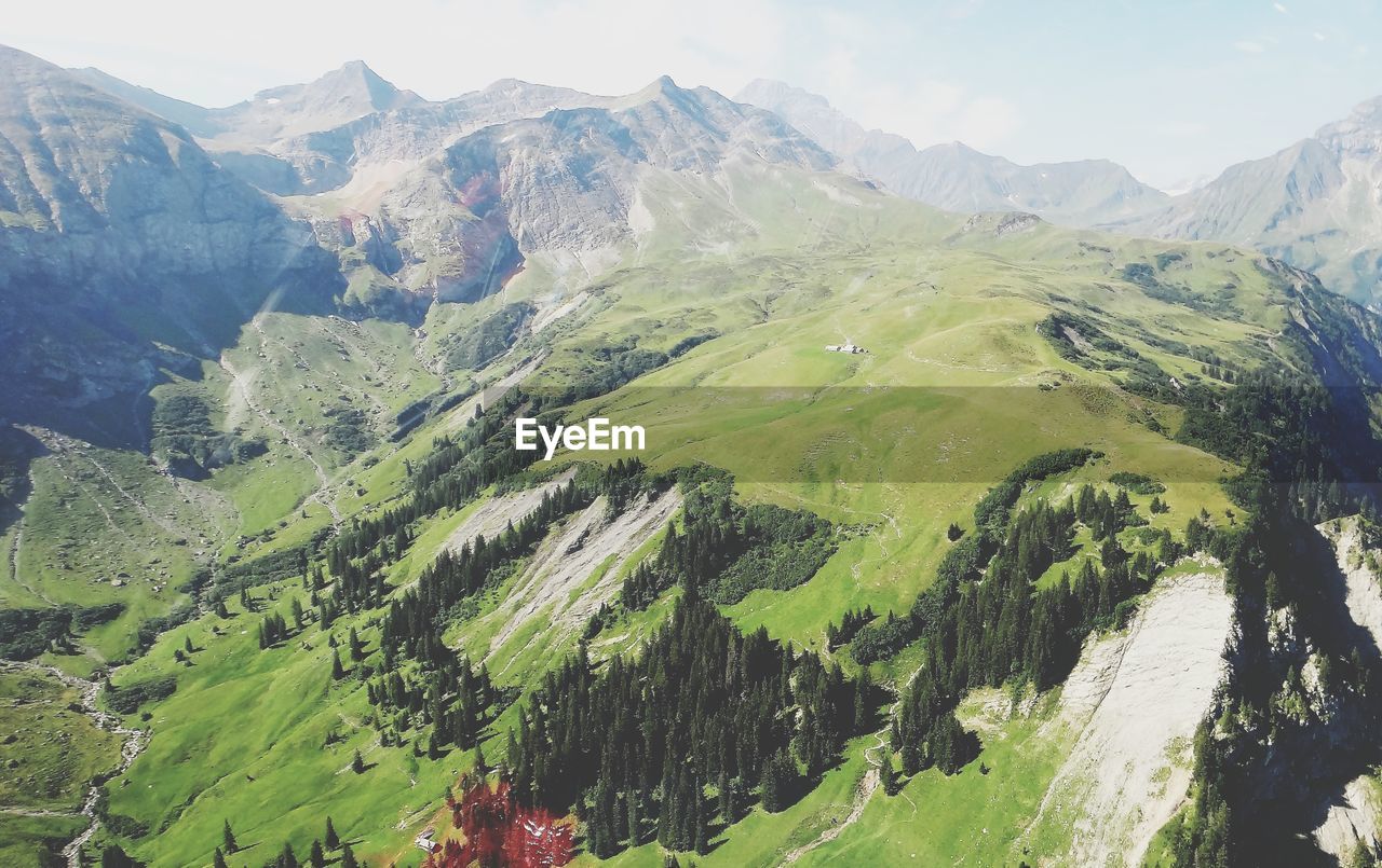 High angle view of land and mountains against sky