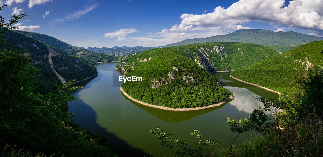 High angle view of lake amidst mountains against sky