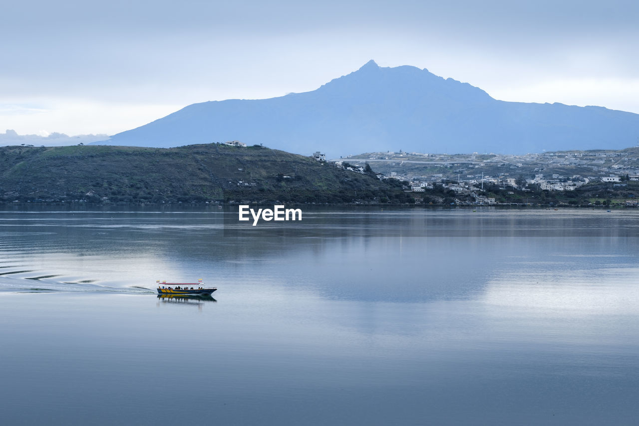 BOAT IN LAKE AGAINST SKY