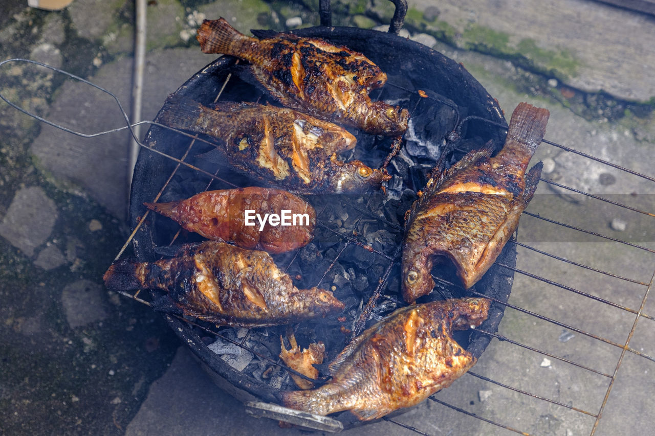 High angle view of meat on barbecue grill
