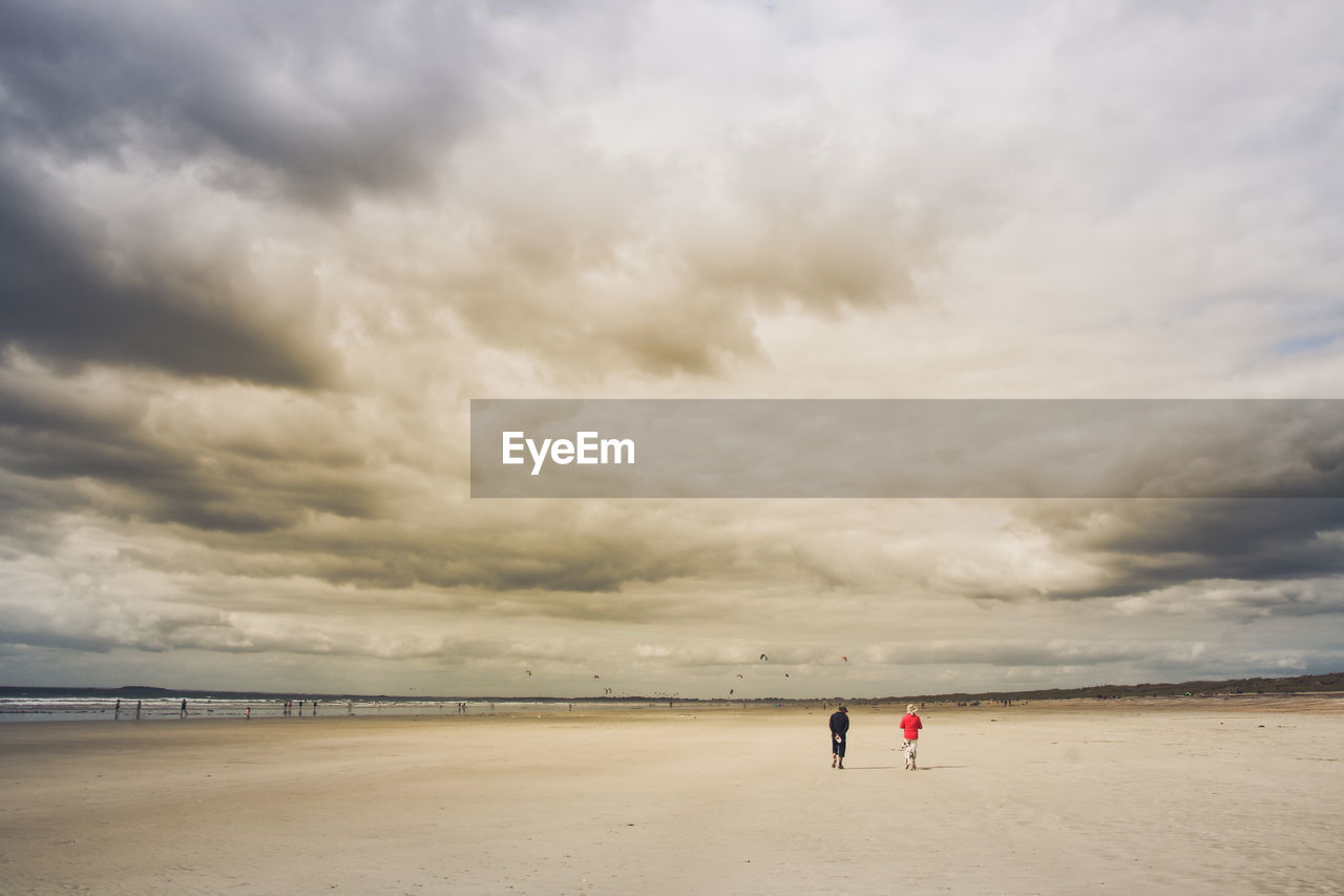 People on beach against sky