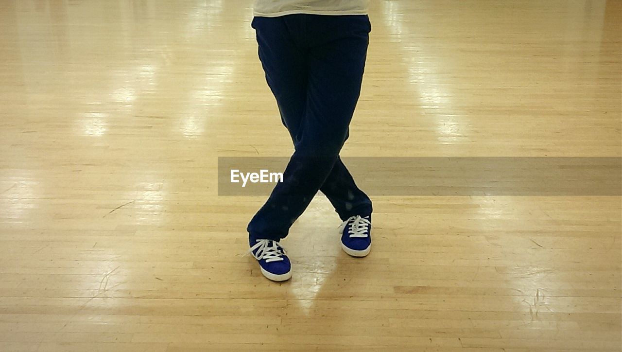 WOMAN STANDING ON TILED FLOOR