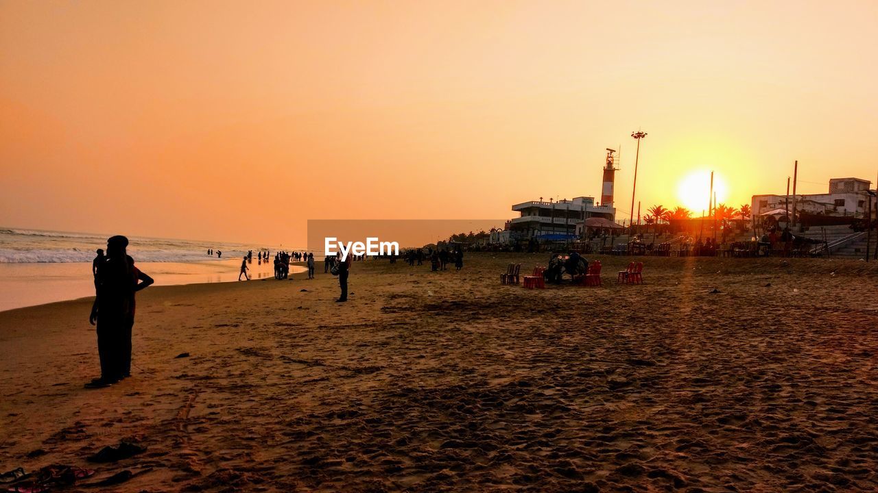 PEOPLE AT BEACH DURING SUNSET