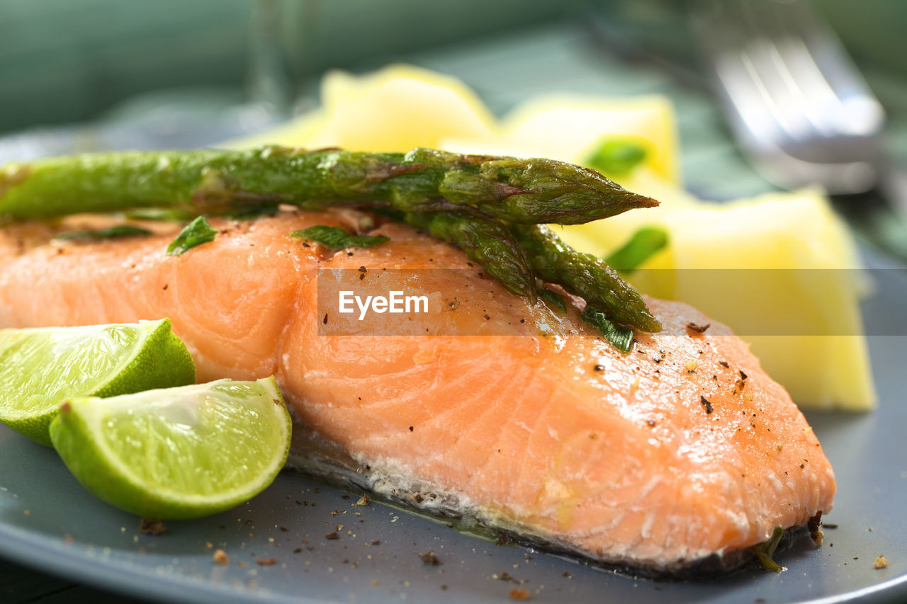 CLOSE-UP OF FISH AND VEGETABLES IN PLATE