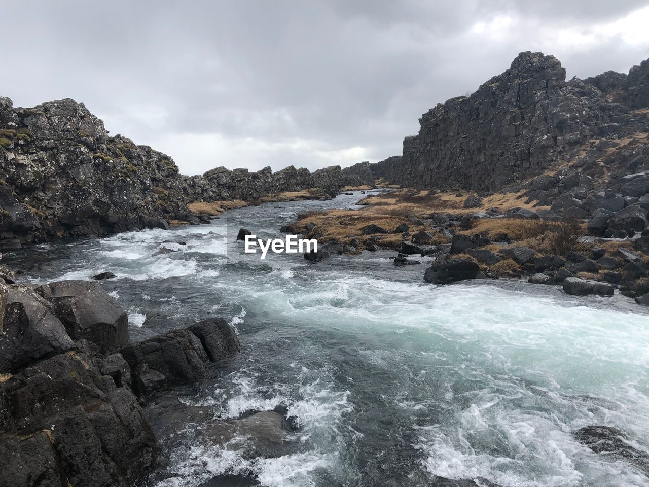 Rocks in sea against sky