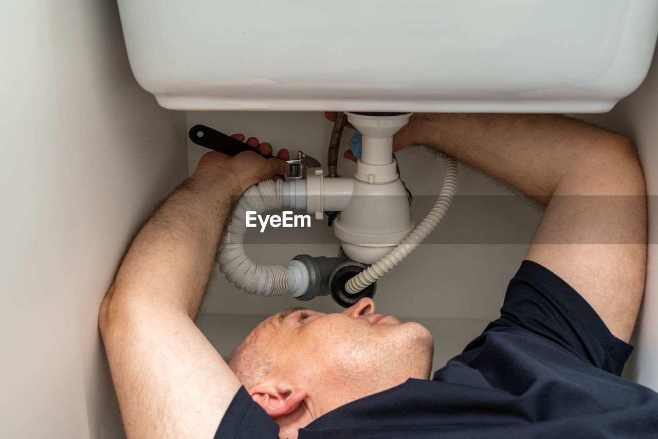 cropped hand of man washing hands