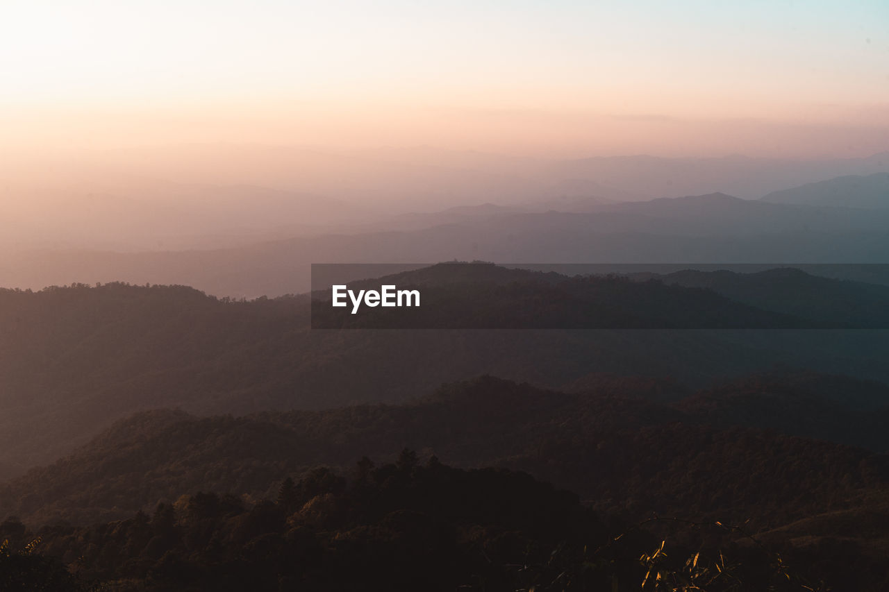 SILHOUETTE MOUNTAINS AGAINST SKY DURING SUNSET