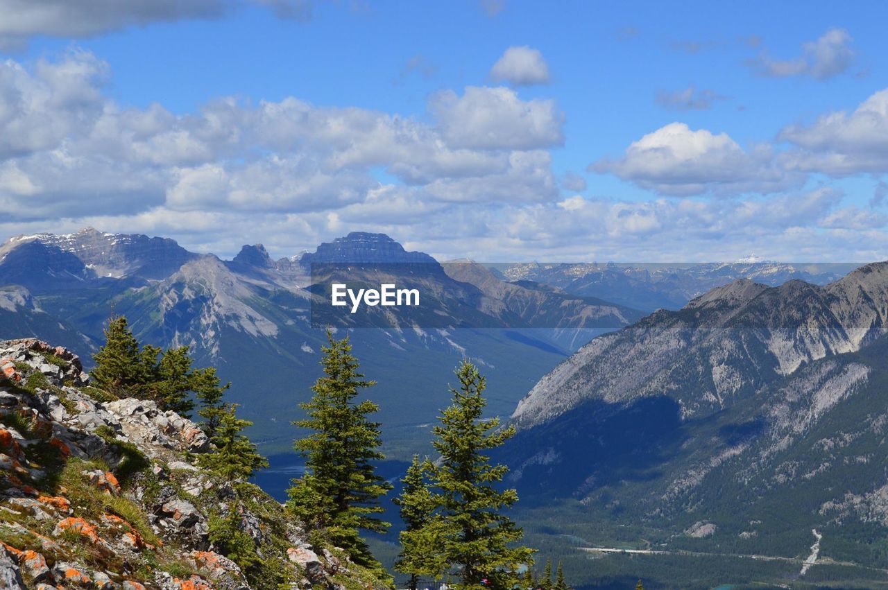 Majestic mountain range against cloudy sky