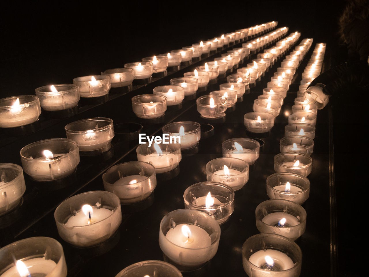 Row of votive candles or prayer candles in a church