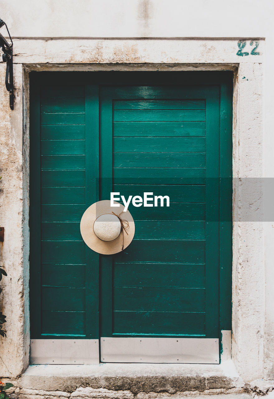 Old green wooden door, hat, minimalism, minimalist architecture, entrance.