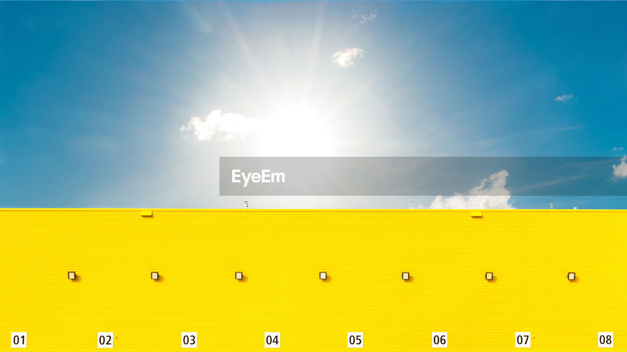 Low angle view of yellow building against sky