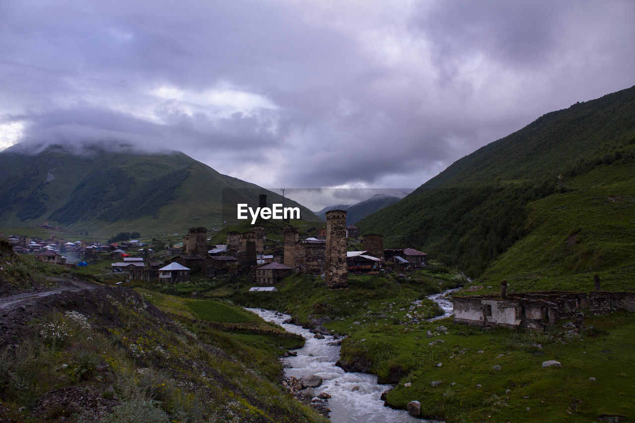 scenic view of mountains against cloudy sky