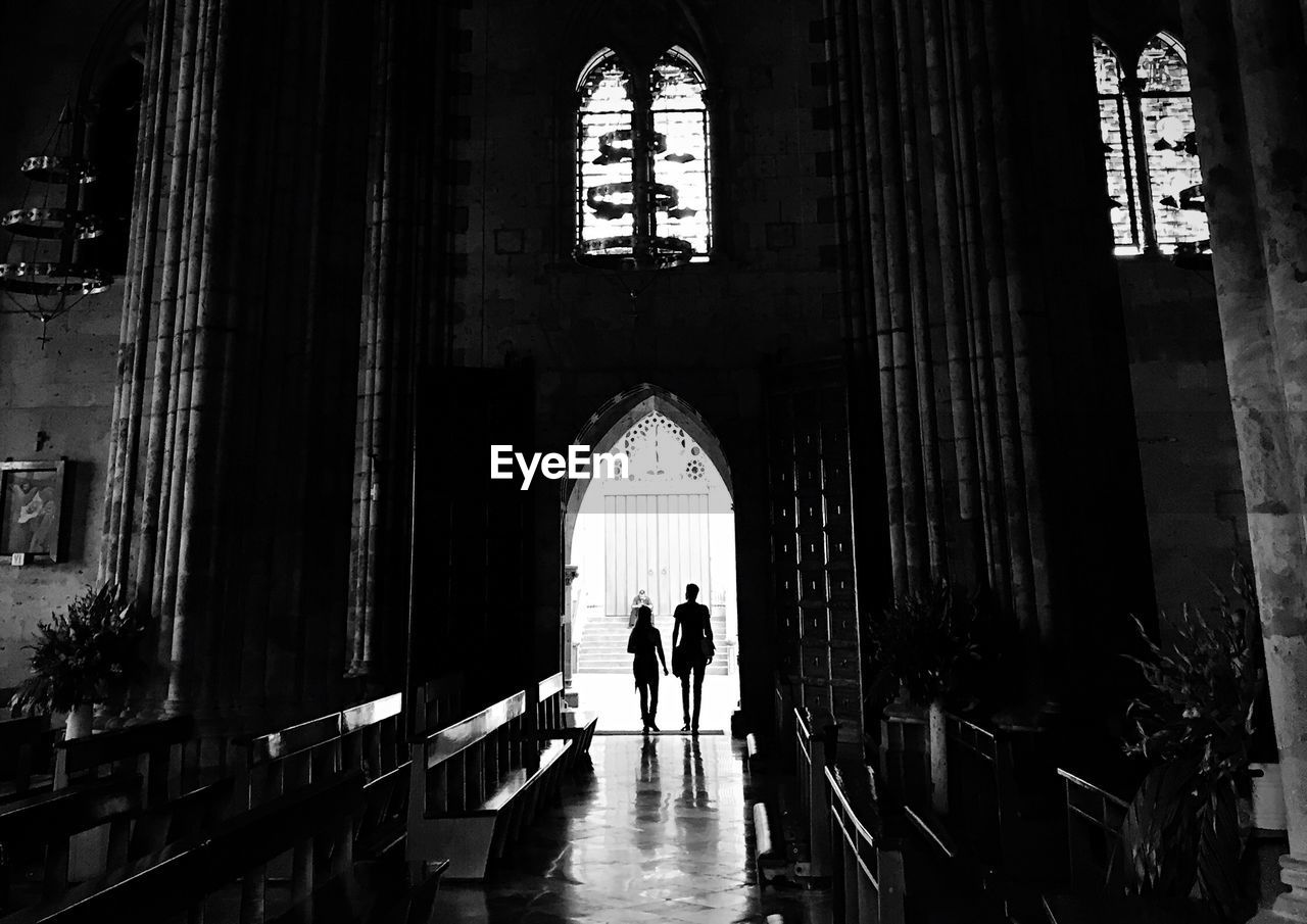 Silhouette people entering in the church