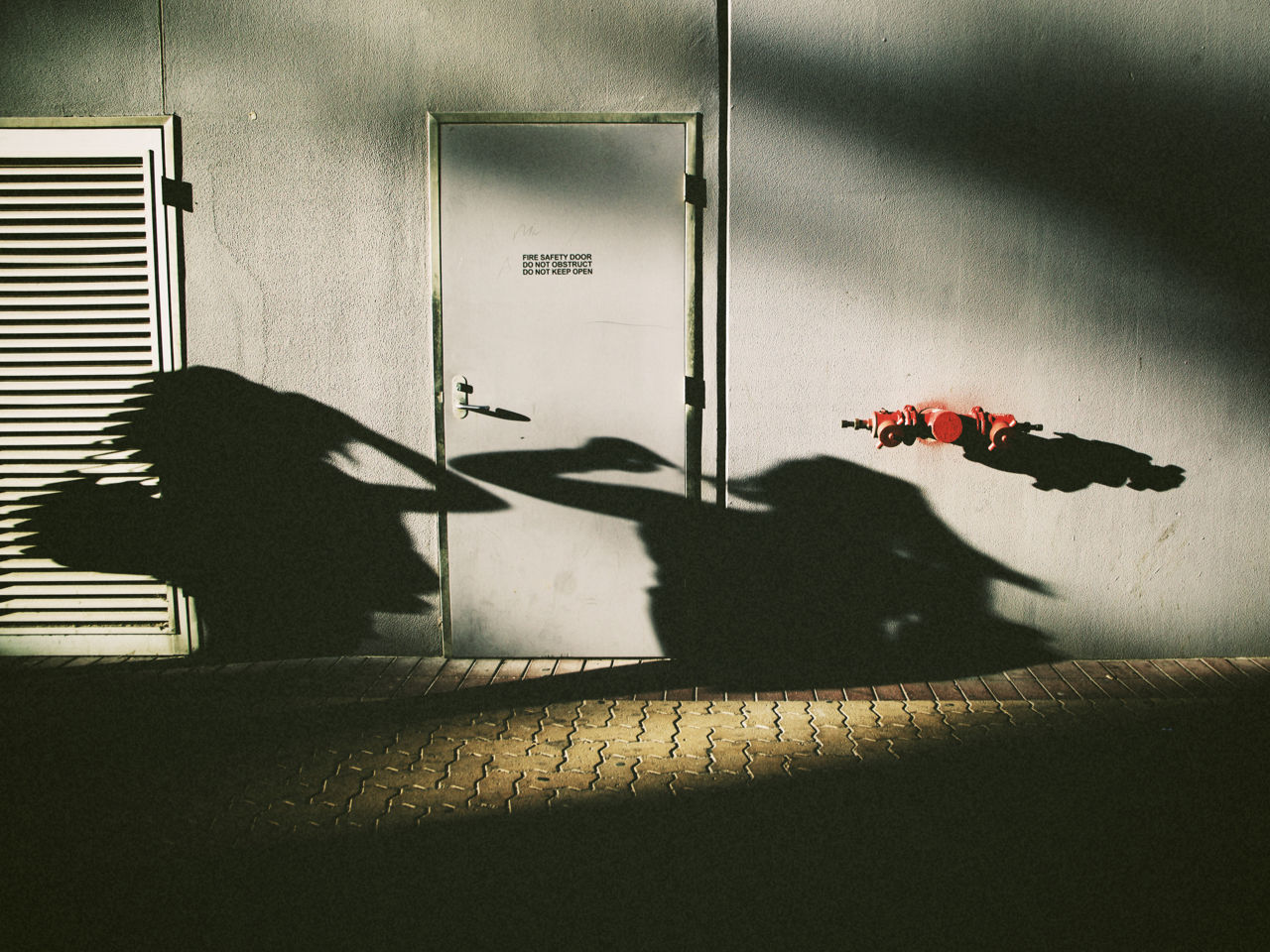 Shadow of two people against building exterior