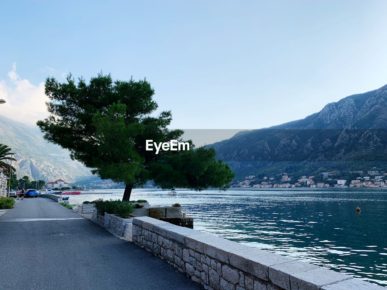 Scenic view of river by mountains against clear sky