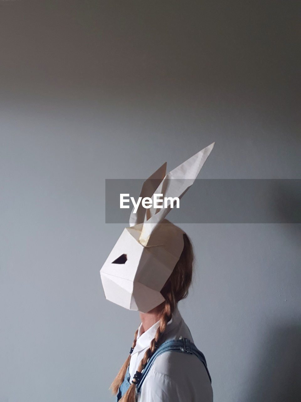 Woman wearing paper rabbit mask