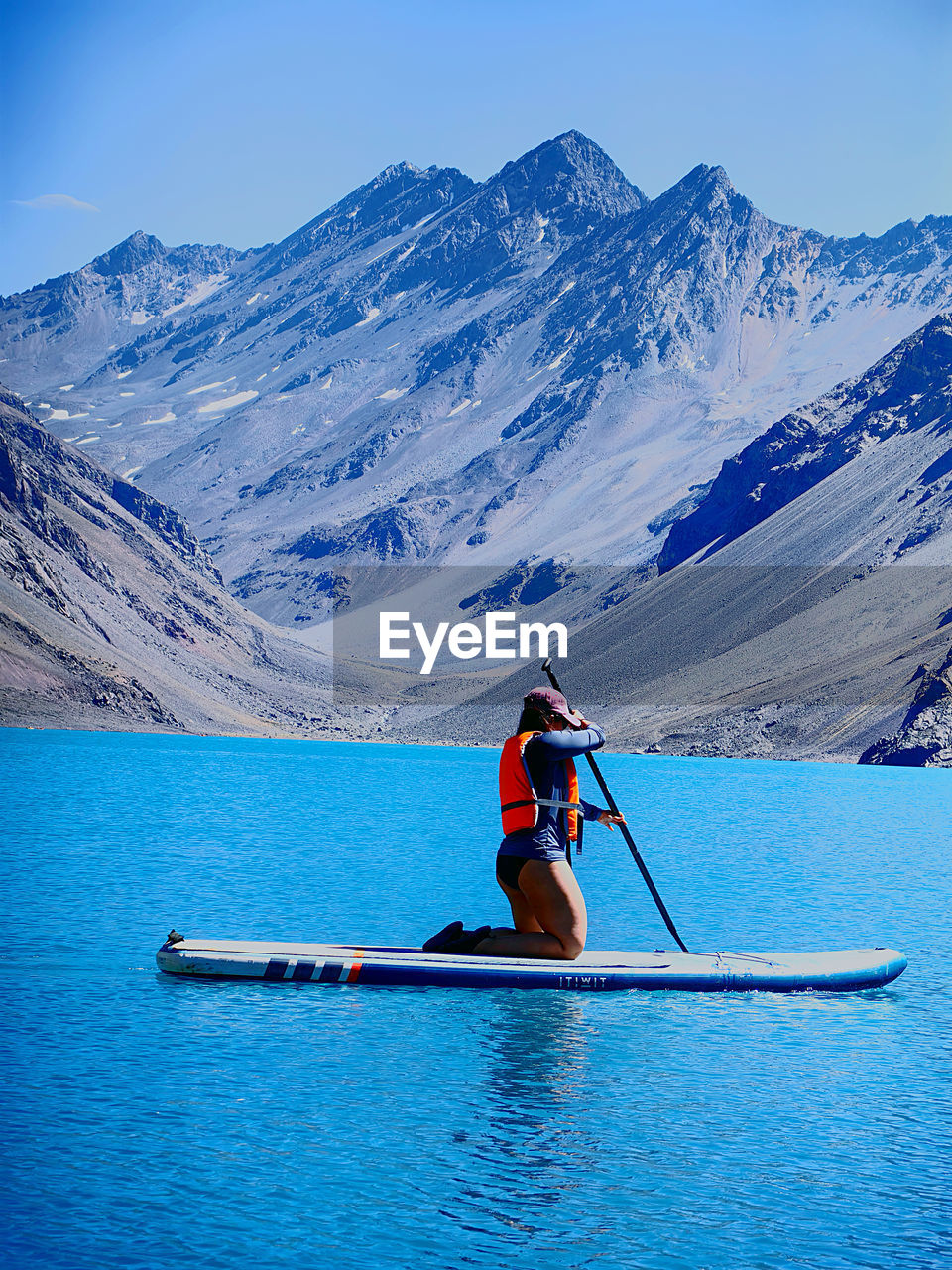 rear view of man kayaking in lake