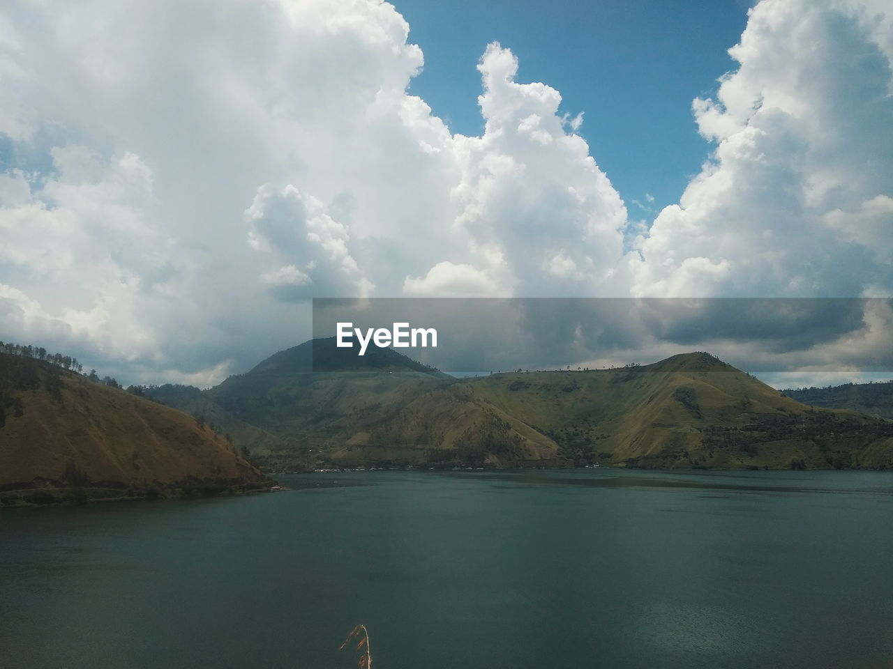 Scenic view of lake and mountains against sky