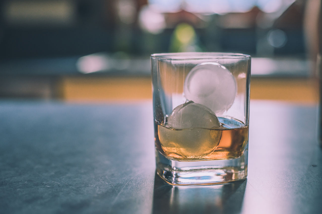 Close-up of whiskey in glass on table