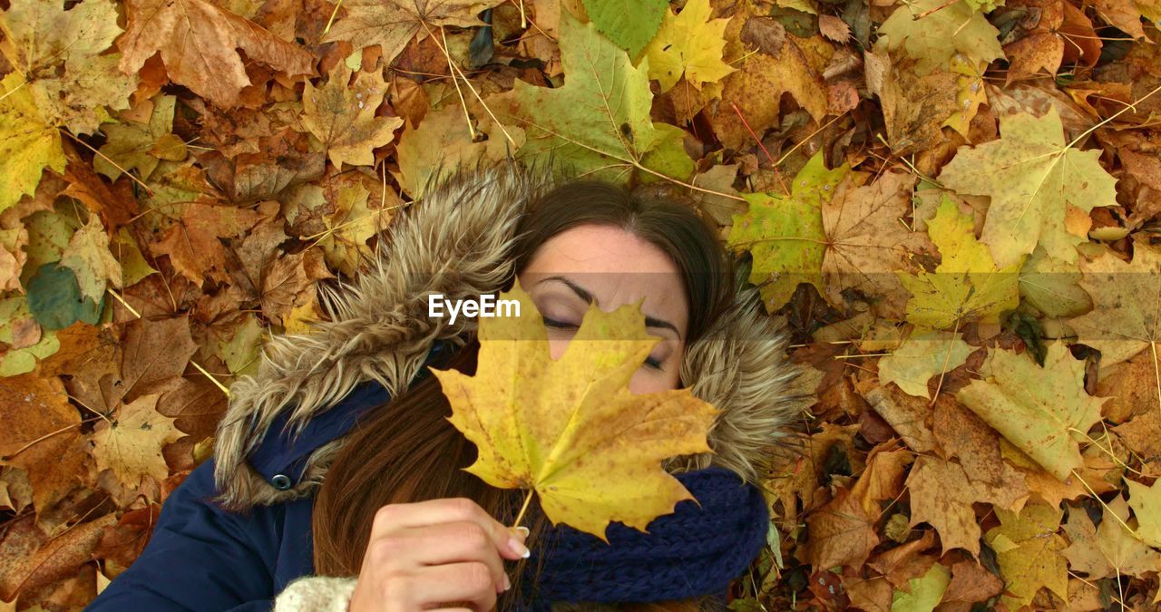 PORTRAIT OF WOMAN WITH YELLOW LEAVES