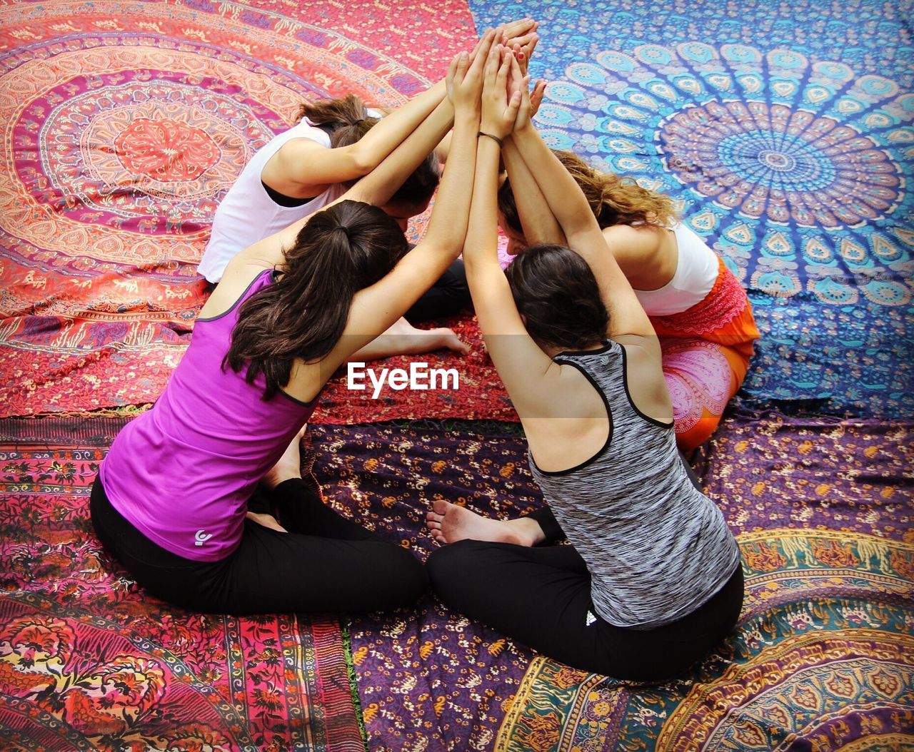 High angle view of women practicing yoga on floor