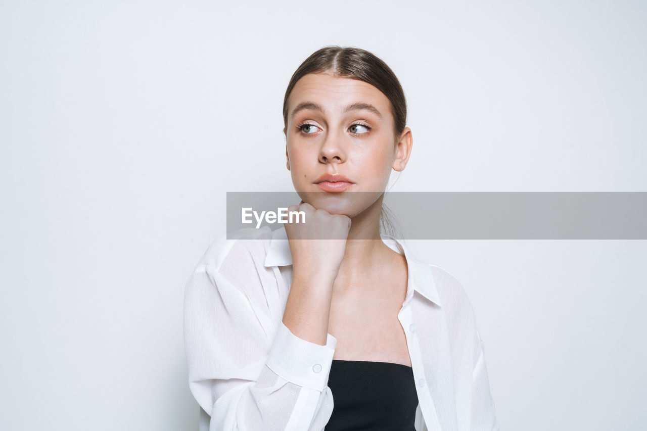 portrait, one person, adult, studio shot, women, indoors, young adult, front view, looking at camera, human face, clothing, photo shoot, person, female, copy space, portrait photography, white background, serious, headshot, contemplation, waist up, white, hand, looking, businesswoman, collar, sleeve, gray, human head, gray background, brown hair, business, emotion