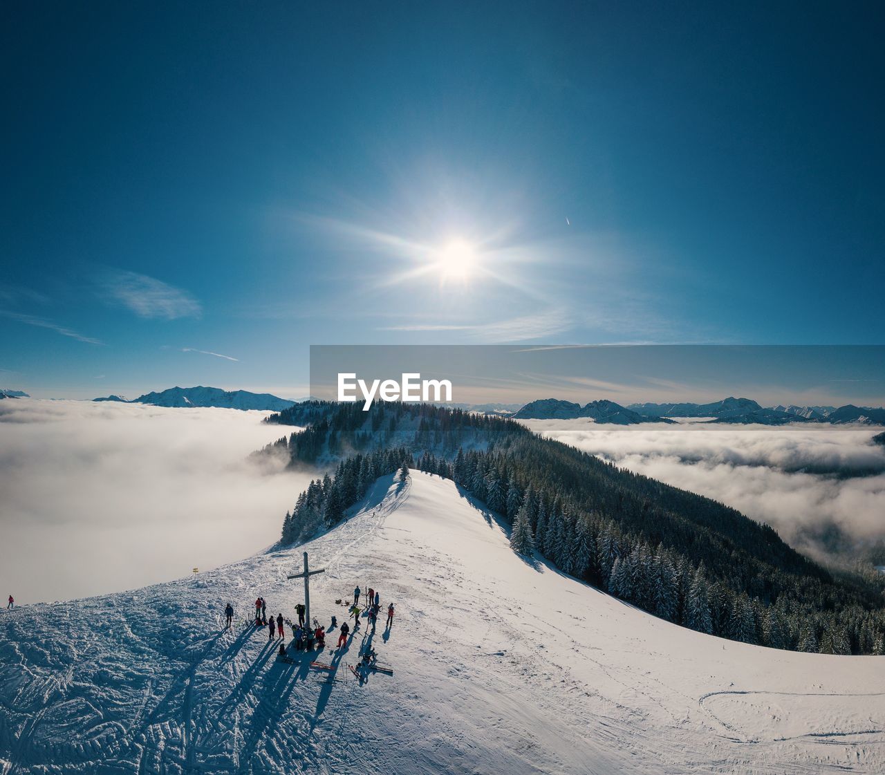 High angle view of people on snowcapped mountain against sky