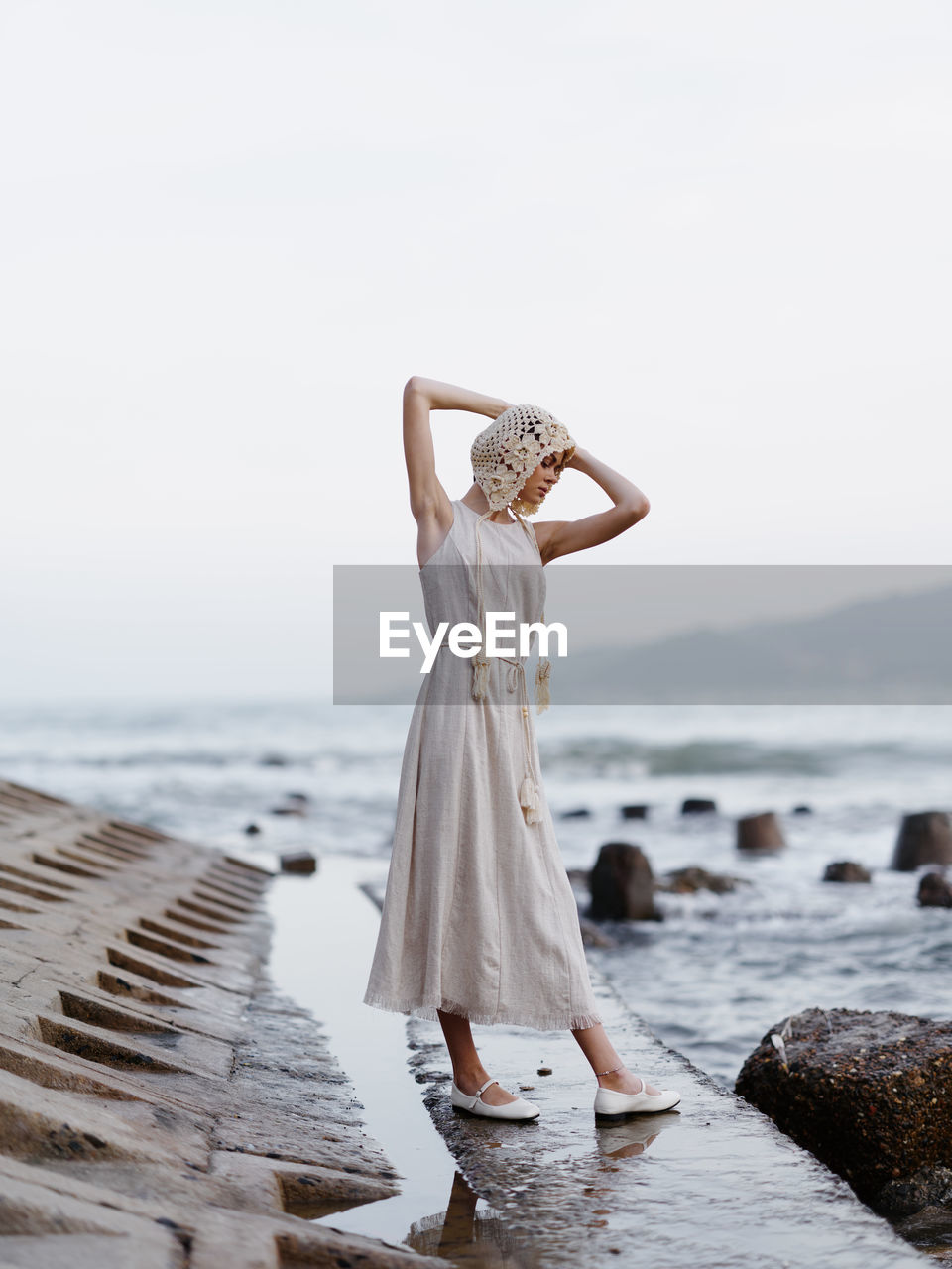 portrait of young woman standing at beach