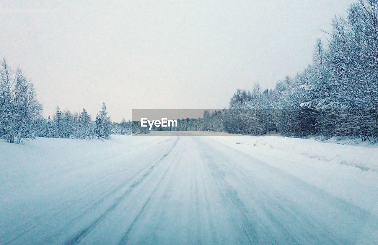 Snow covered landscape against sky