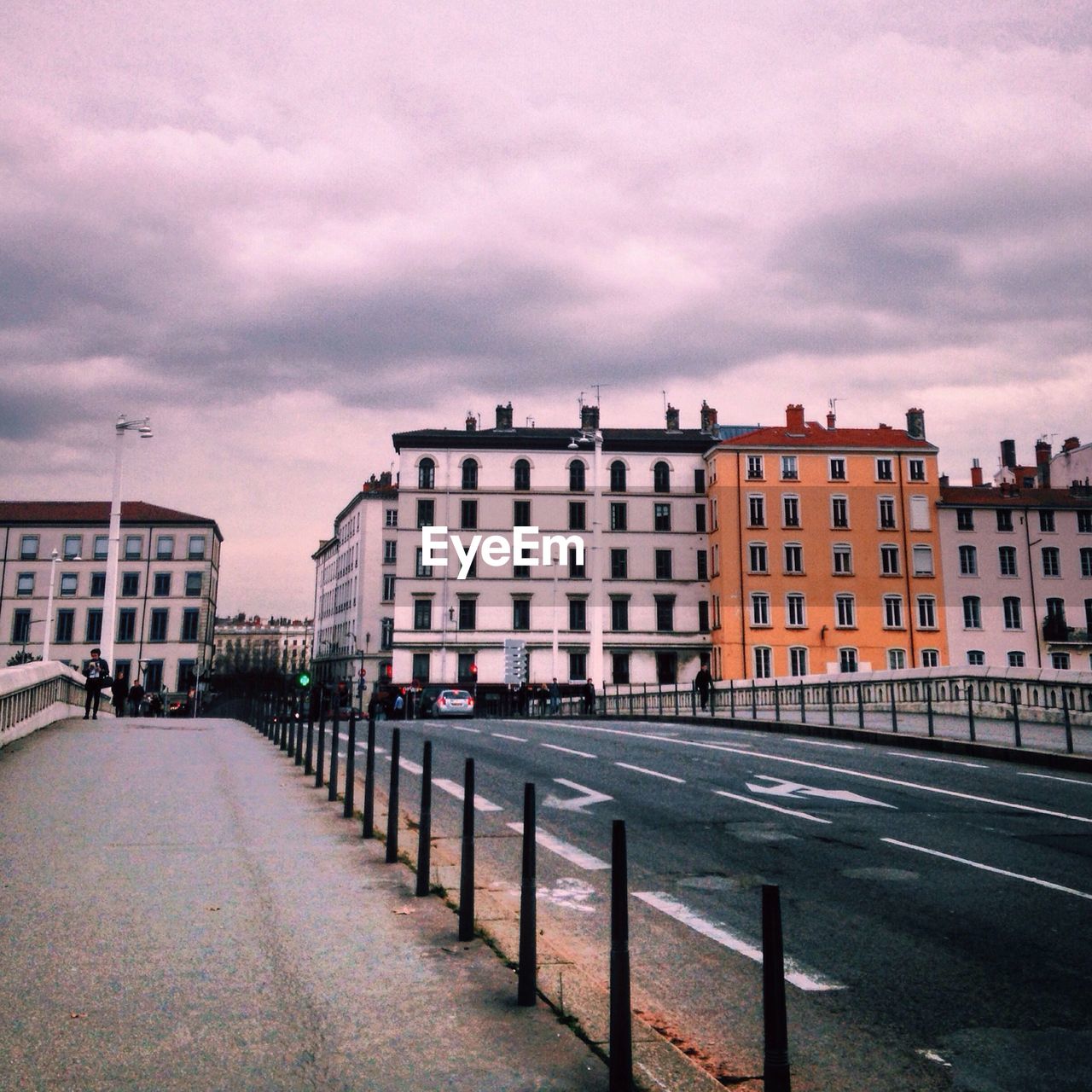 Empty road against buildings