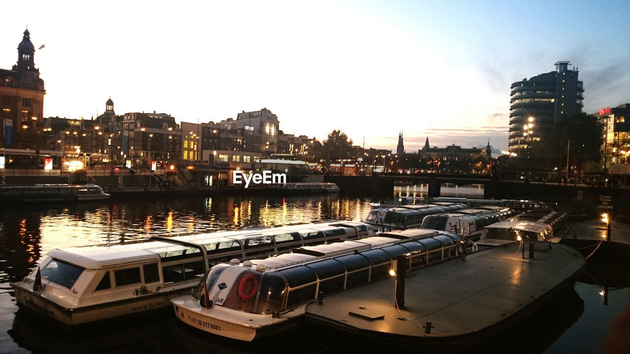 AERIAL VIEW OF ILLUMINATED CITY AT SUNSET