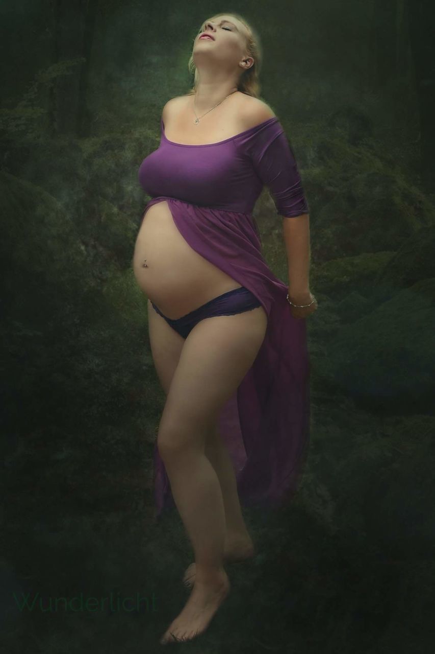 Full length of pregnant woman standing on field