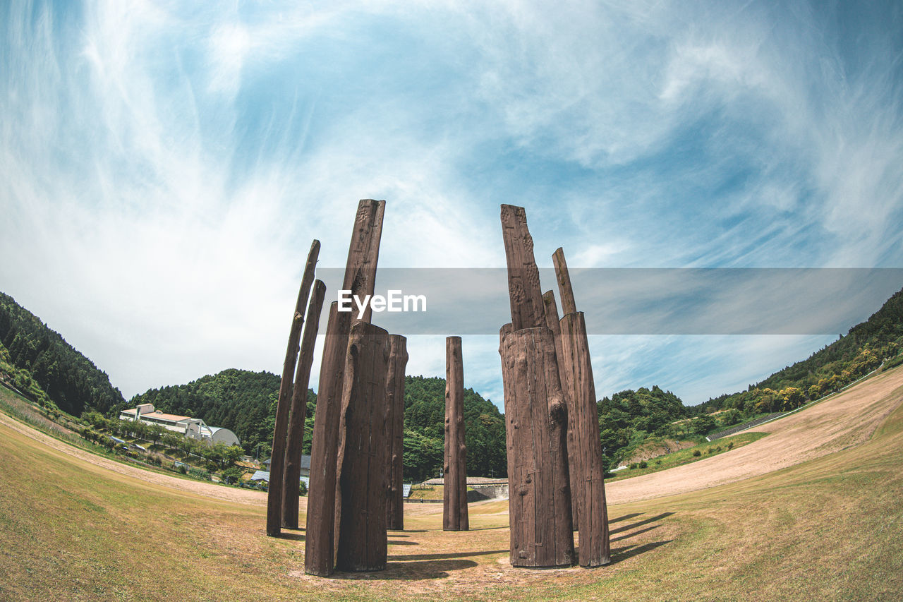 sky, landscape, nature, cloud, environment, land, scenics - nature, plant, travel destinations, travel, no people, beauty in nature, grass, mountain, panoramic, architecture, history, outdoors, tranquility, blue, rural scene, non-urban scene, the past, landmark, rock, tranquil scene, sunlight, field, day, tree