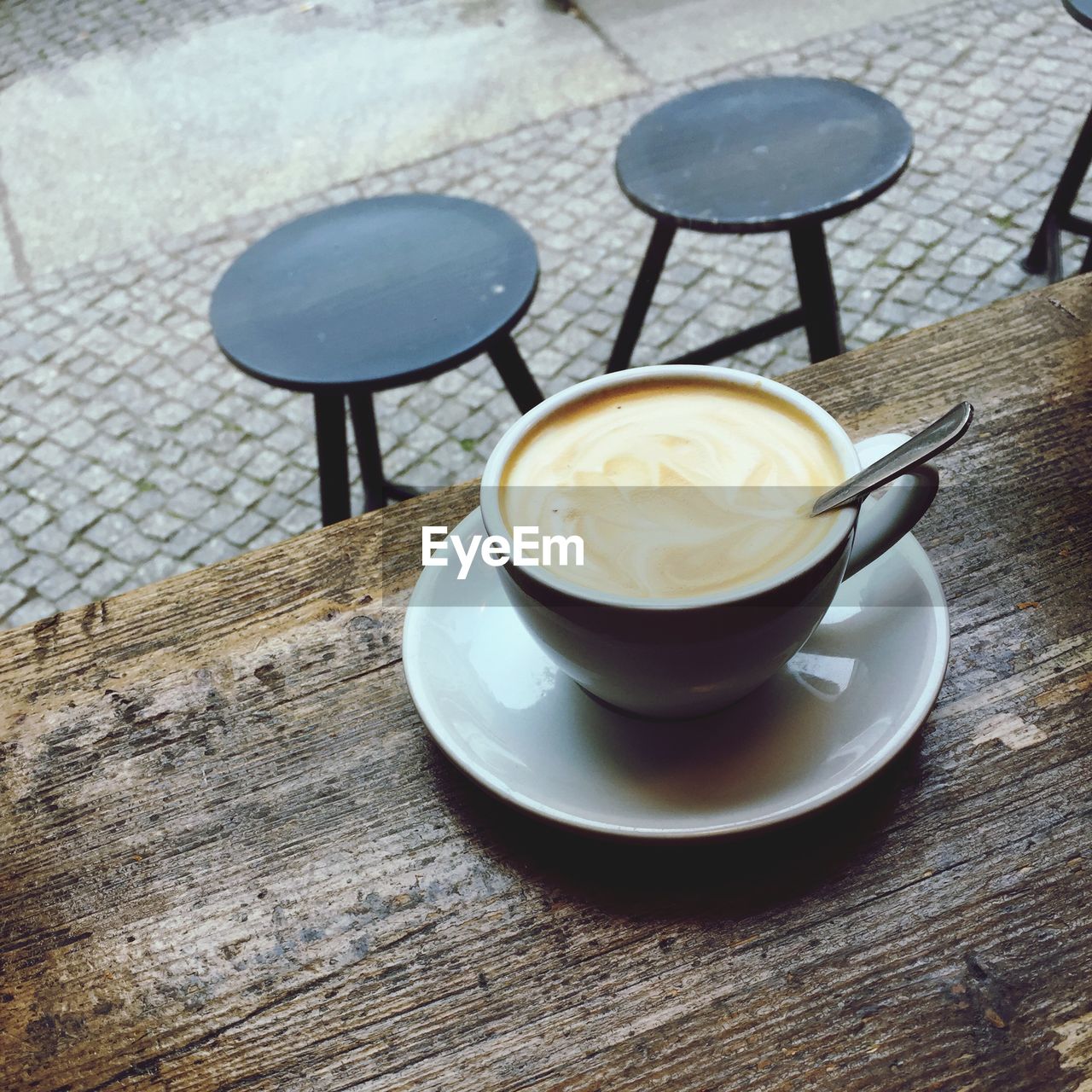 High angle view of cappuccino on table at cafe