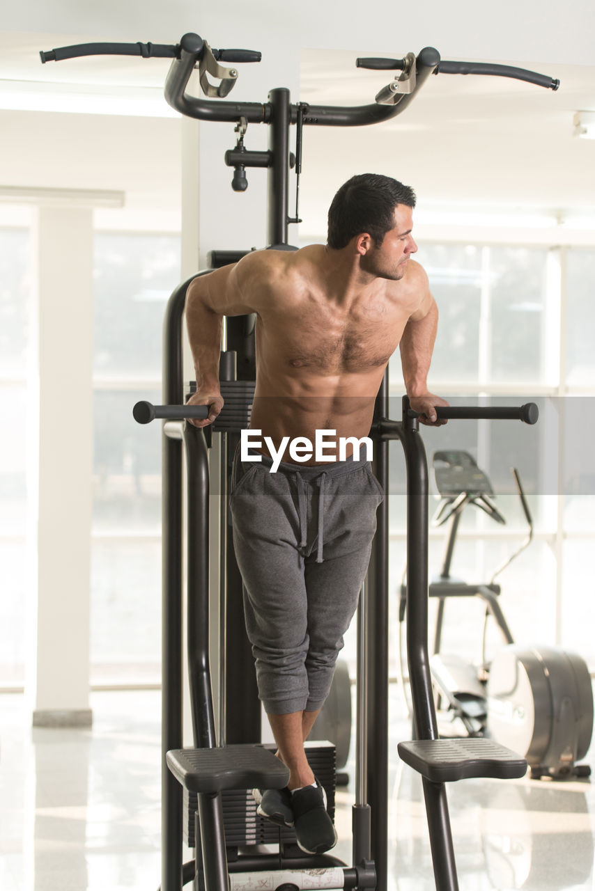 Muscular man exercising in gym