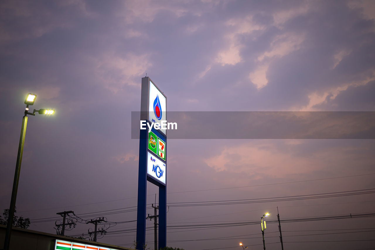 LOW ANGLE VIEW OF ILLUMINATED LIGHT AGAINST SKY