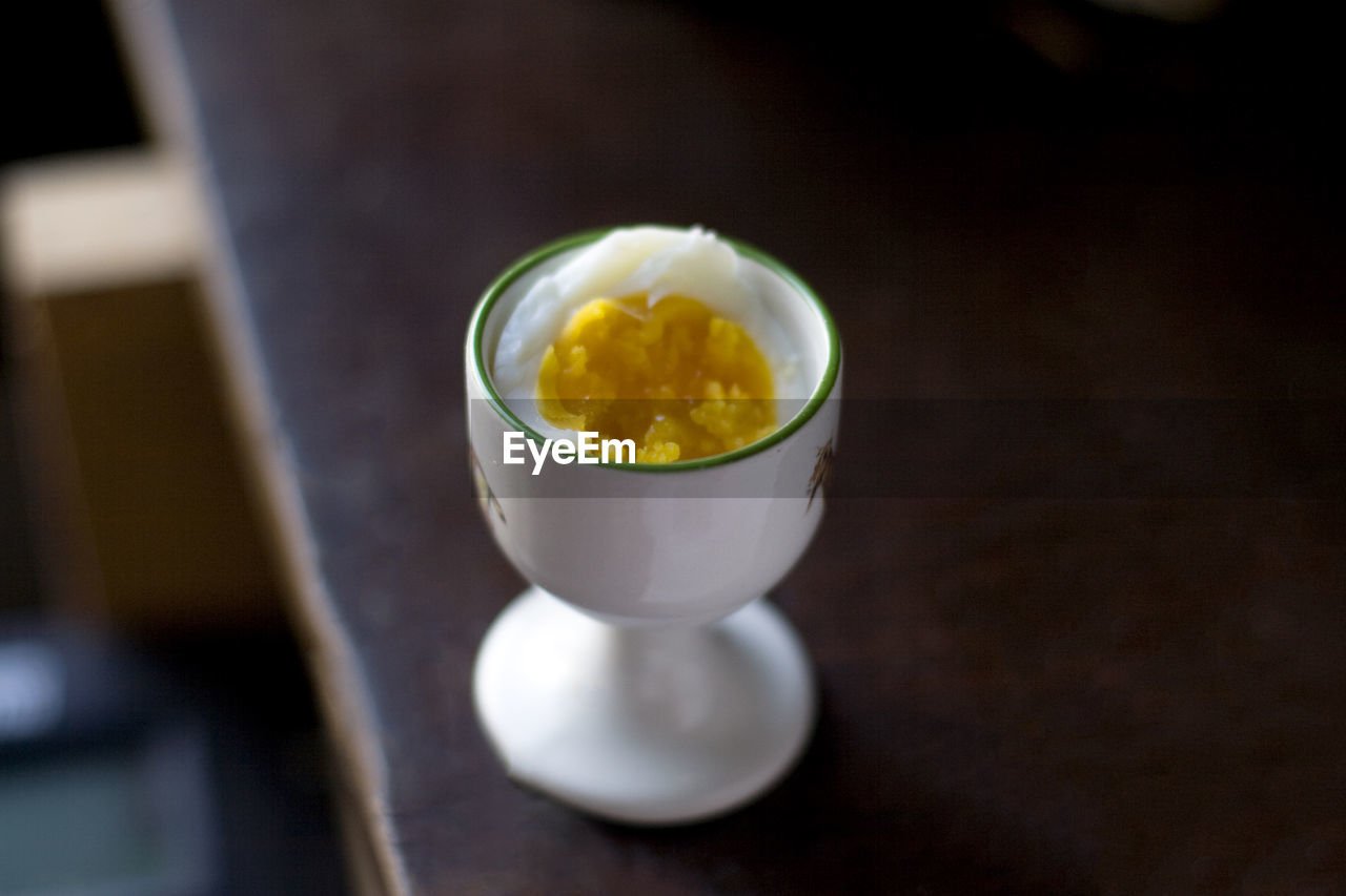 High angle view of boiled egg in cup on table