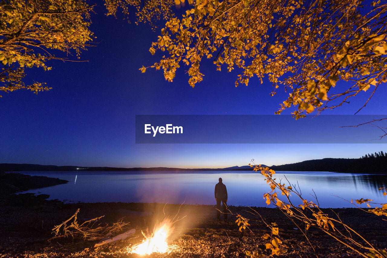 Man standing by lake side