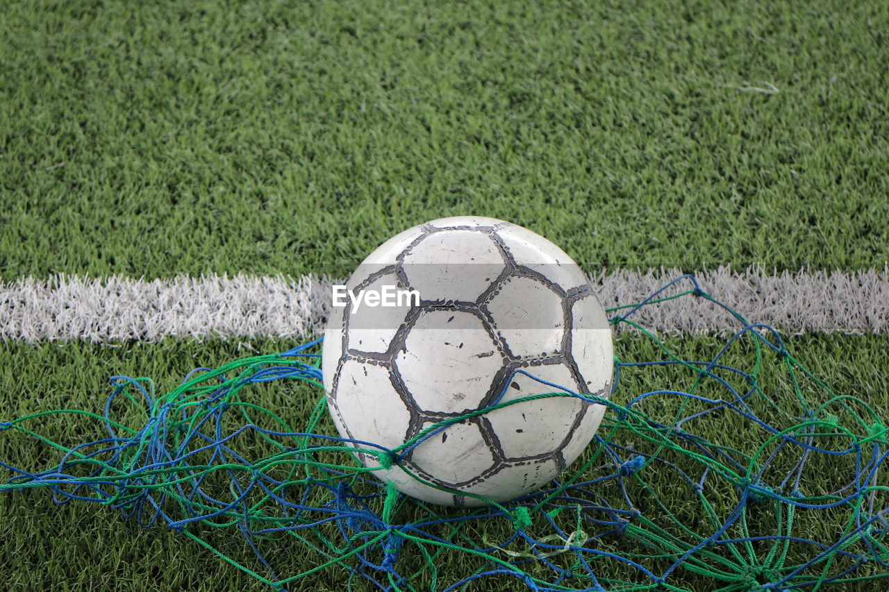 CLOSE-UP OF A BALL ON FIELD