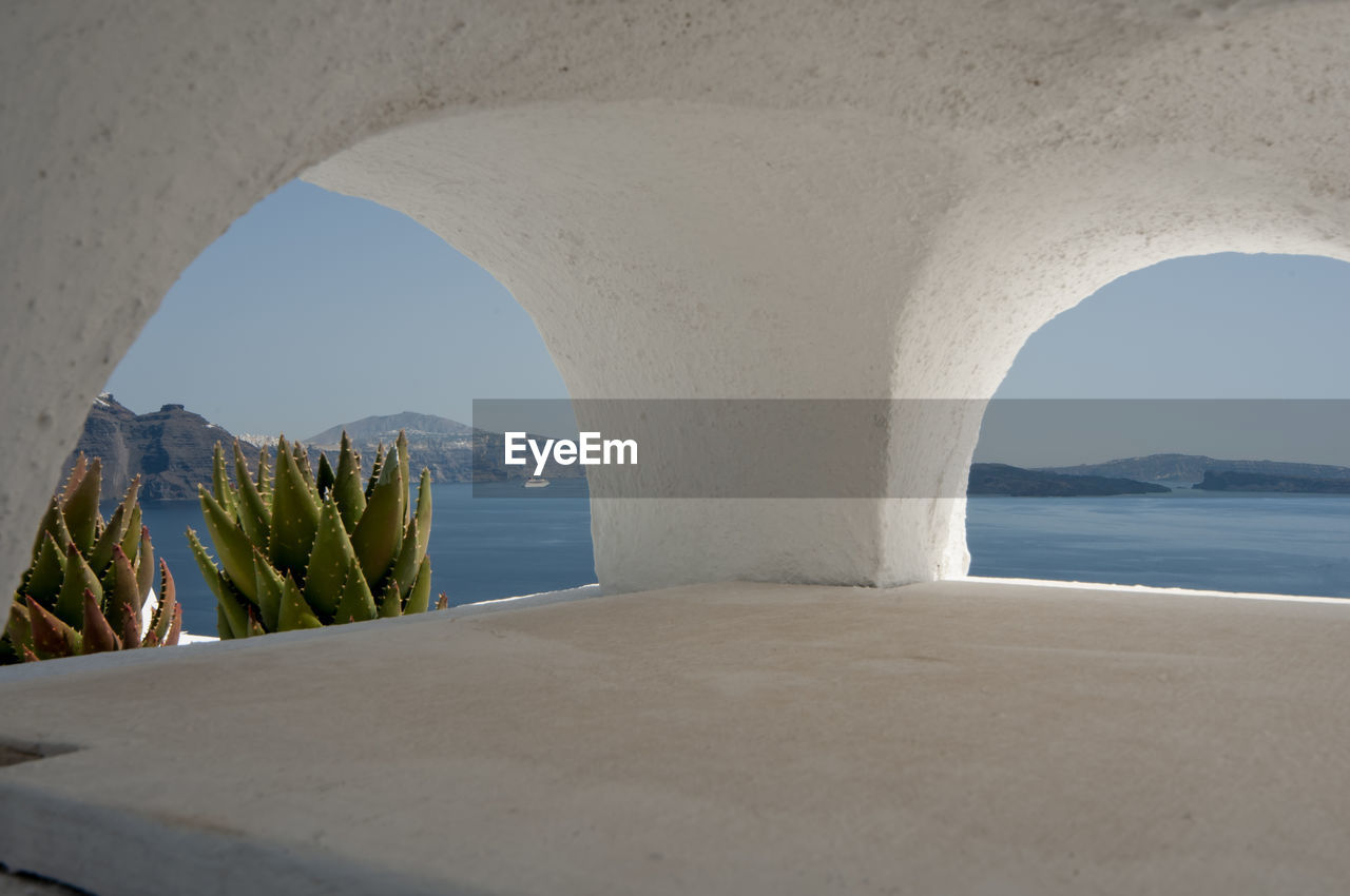 Details of arches of a fireplace with sea view in oia, greece. in the background  aegean sea,