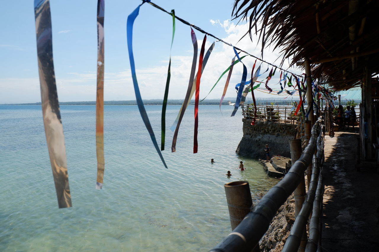 SCENIC VIEW OF WOODEN POST AT BEACH AGAINST SKY