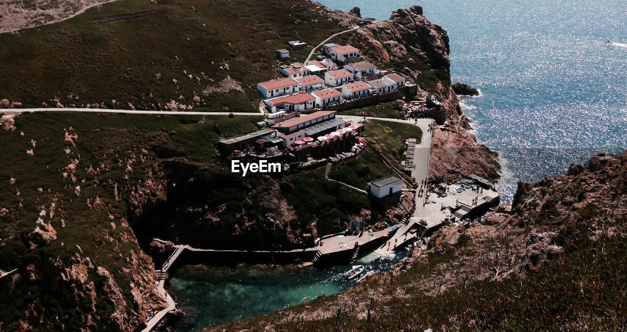 High angle view of houses on mountain by sea