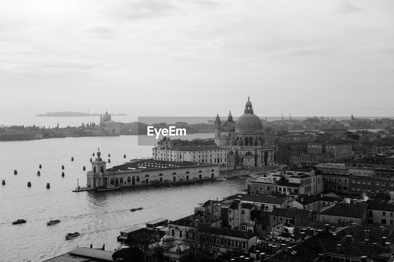 Santa maria della salute by grand canal against sky in city