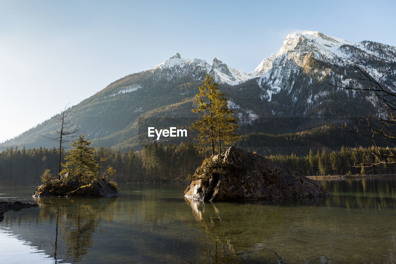 scenic view of lake and snowcapped mountains against clear sky