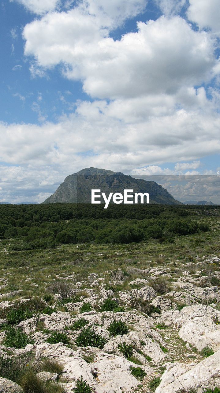 Scenic view of mountains against cloudy sky