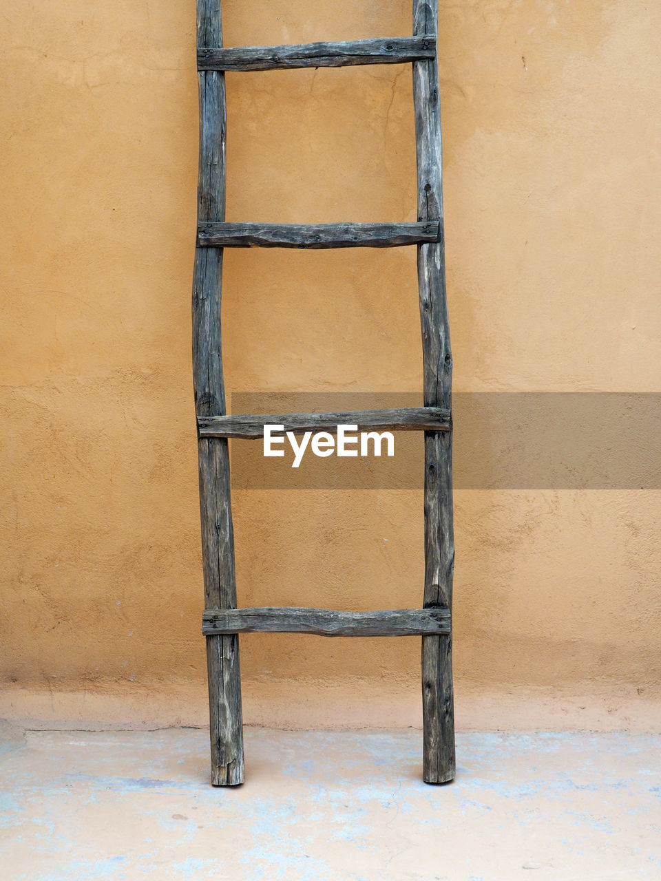 Wooden ladder against wall